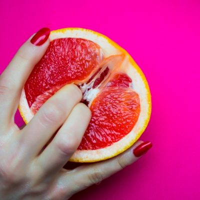 Vagina,Symbol.,Two,Fingers,On,Grapefruit,On,Pink,Background.,Sex